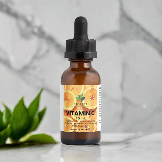 Brown glass bottle with dropper labeled 'Vitamin C Serum' on a white background